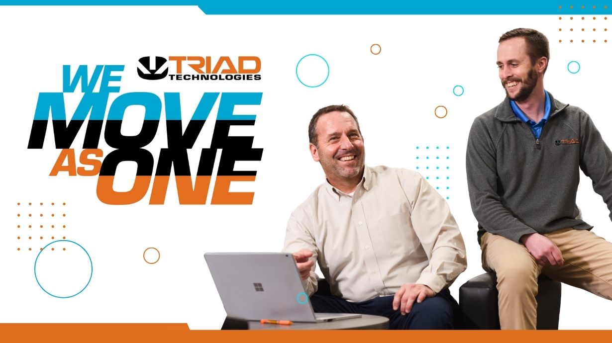 Triad employees with We Move As One team logo