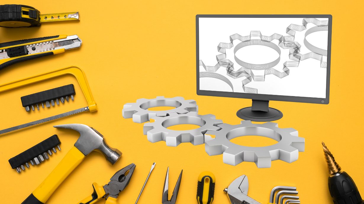Computer and tools on a yellow backdrop