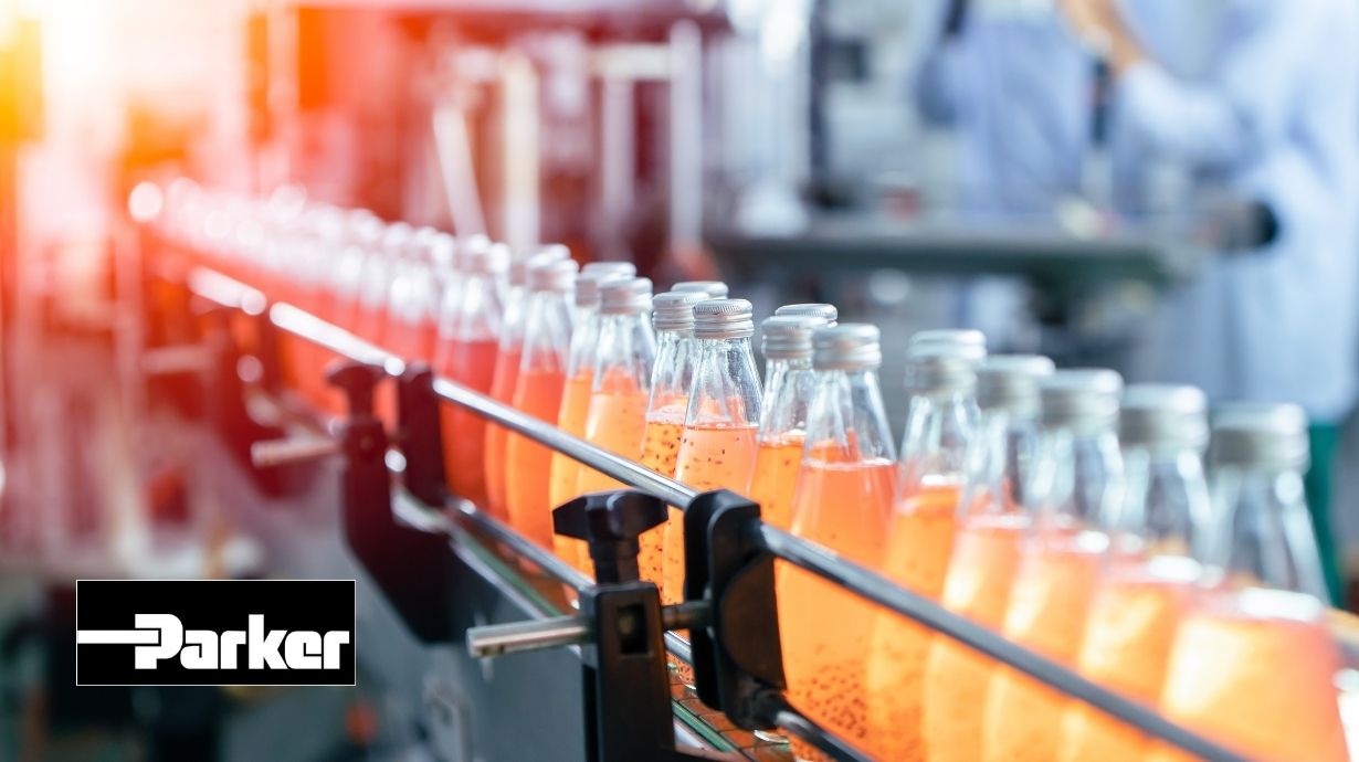 Orange bottles on conveyor during beverage manufacturing