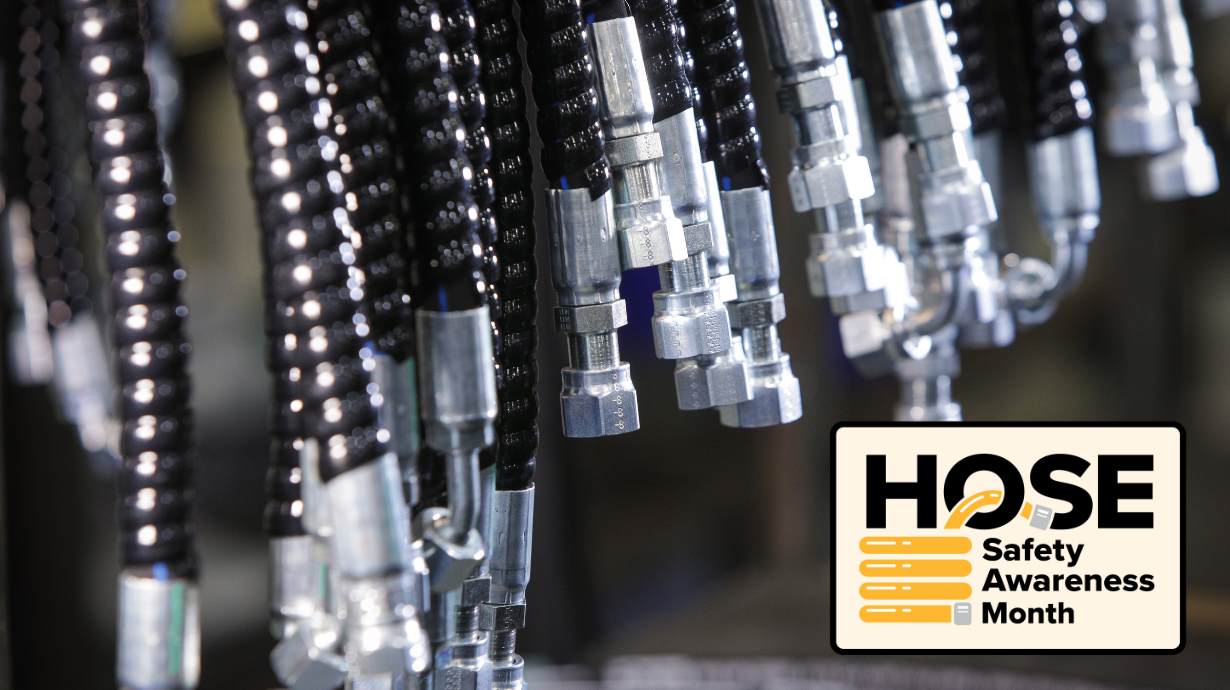 Hydraulic hose assemblies hanging in a row for Hose Safety Awareness Month