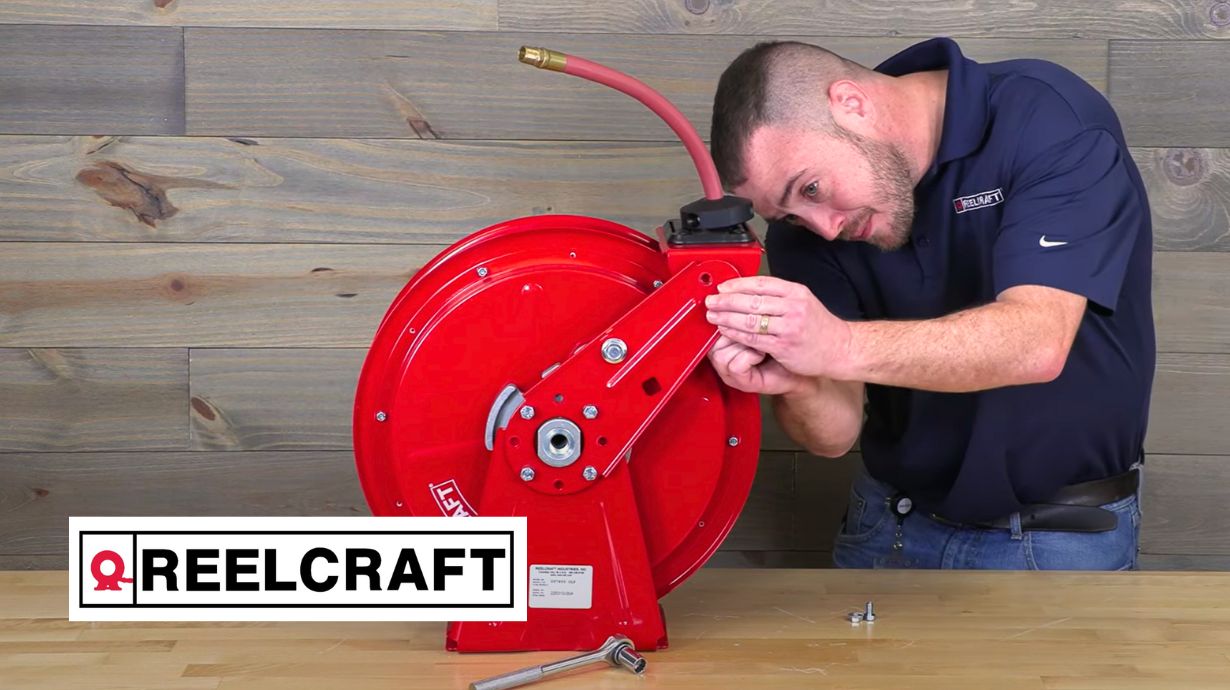 Technician adjusting Reelcraft guide arm