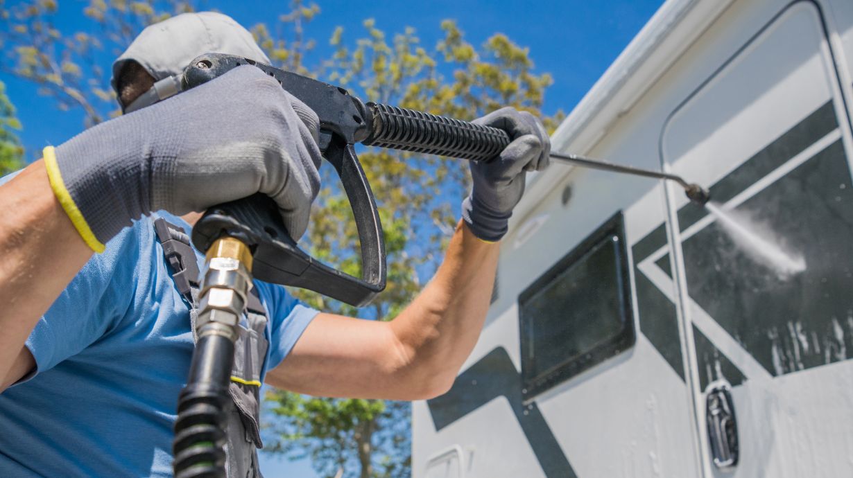 Man spraying window with Pressure Washer