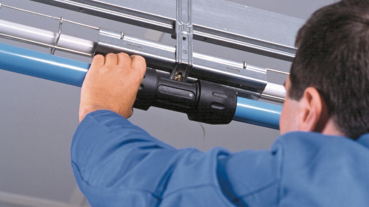 Man installing Transair pipe and fitting