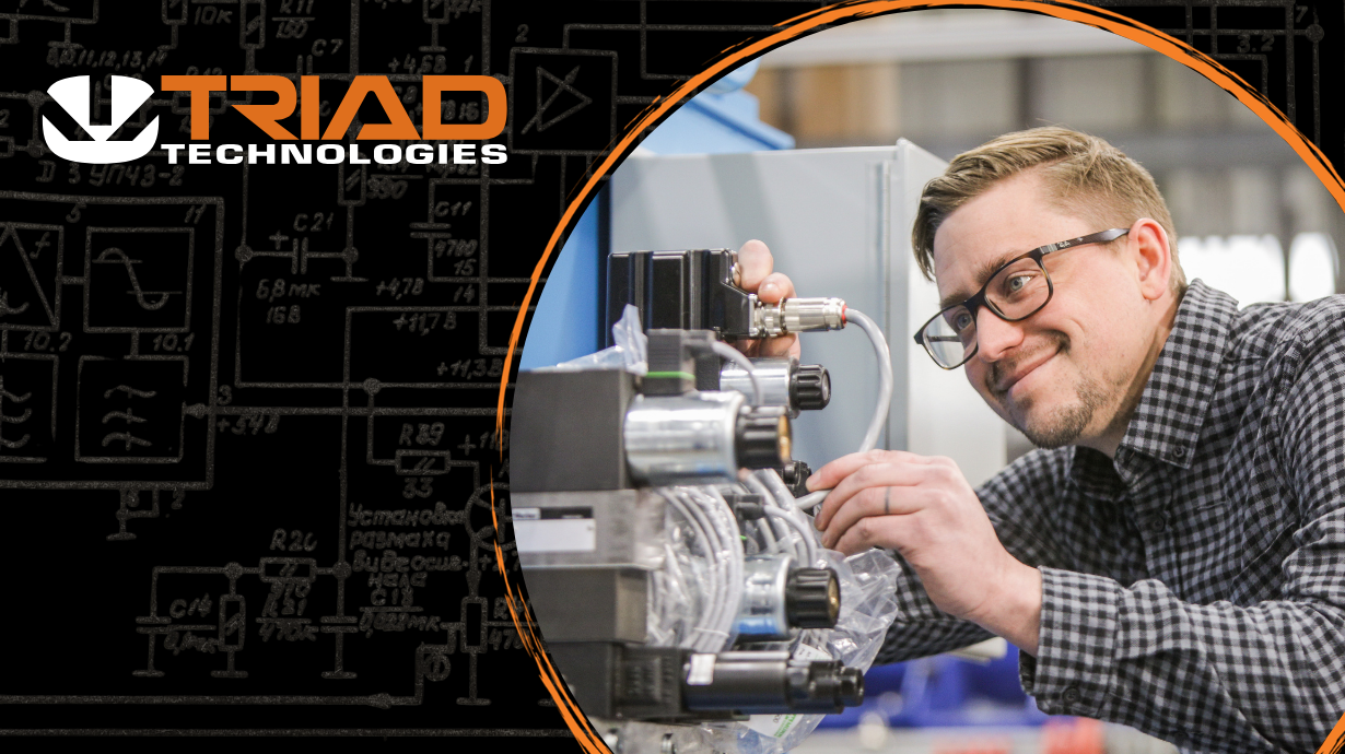 Triad logo with person working on a piece of hydraulic equipment